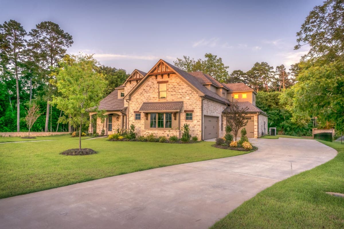 Stone-and-timber home at golden hour with a fresh architectural shingle roof