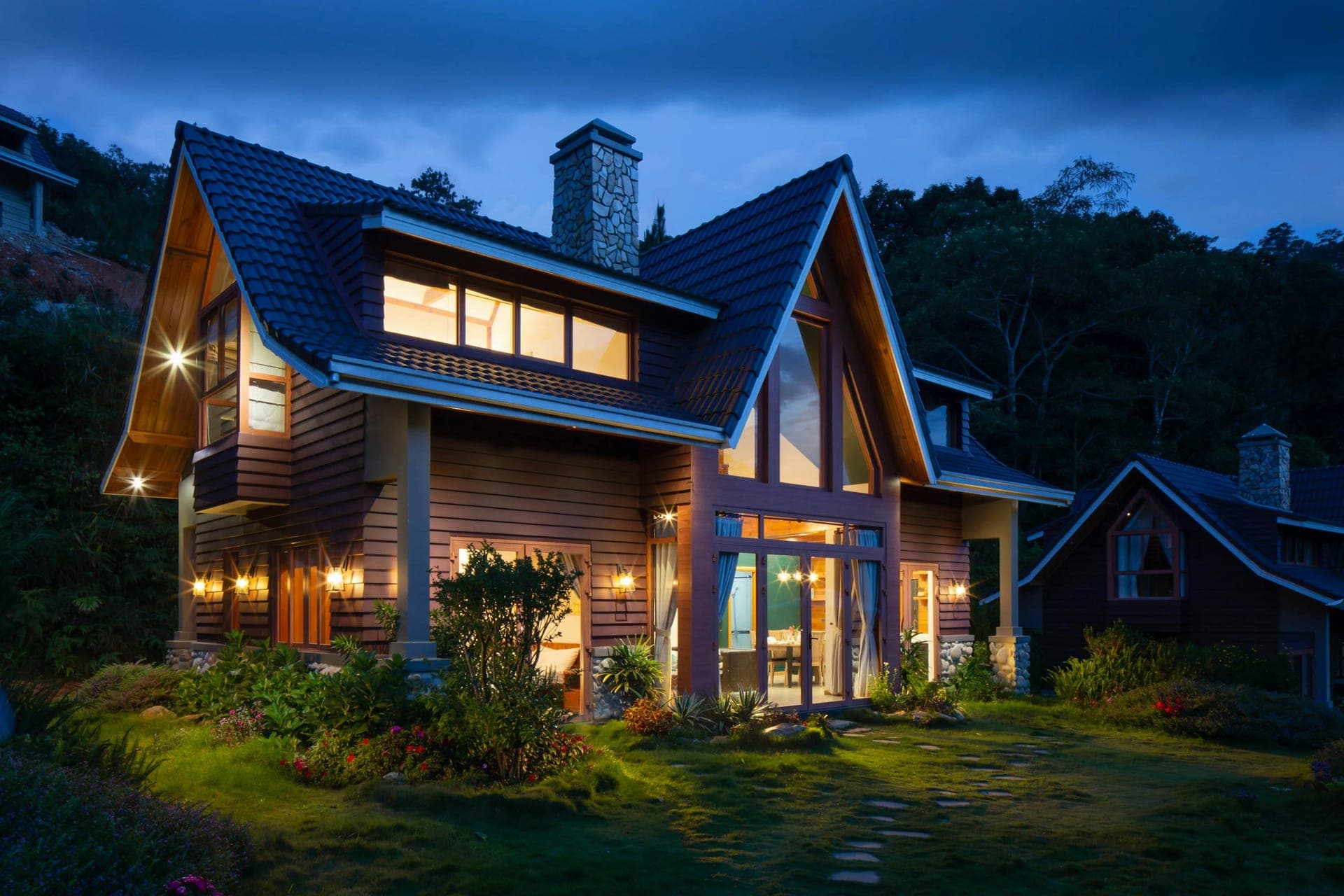 Craftsman home in the metro at dusk, new architectural roof against a heavy storm sky